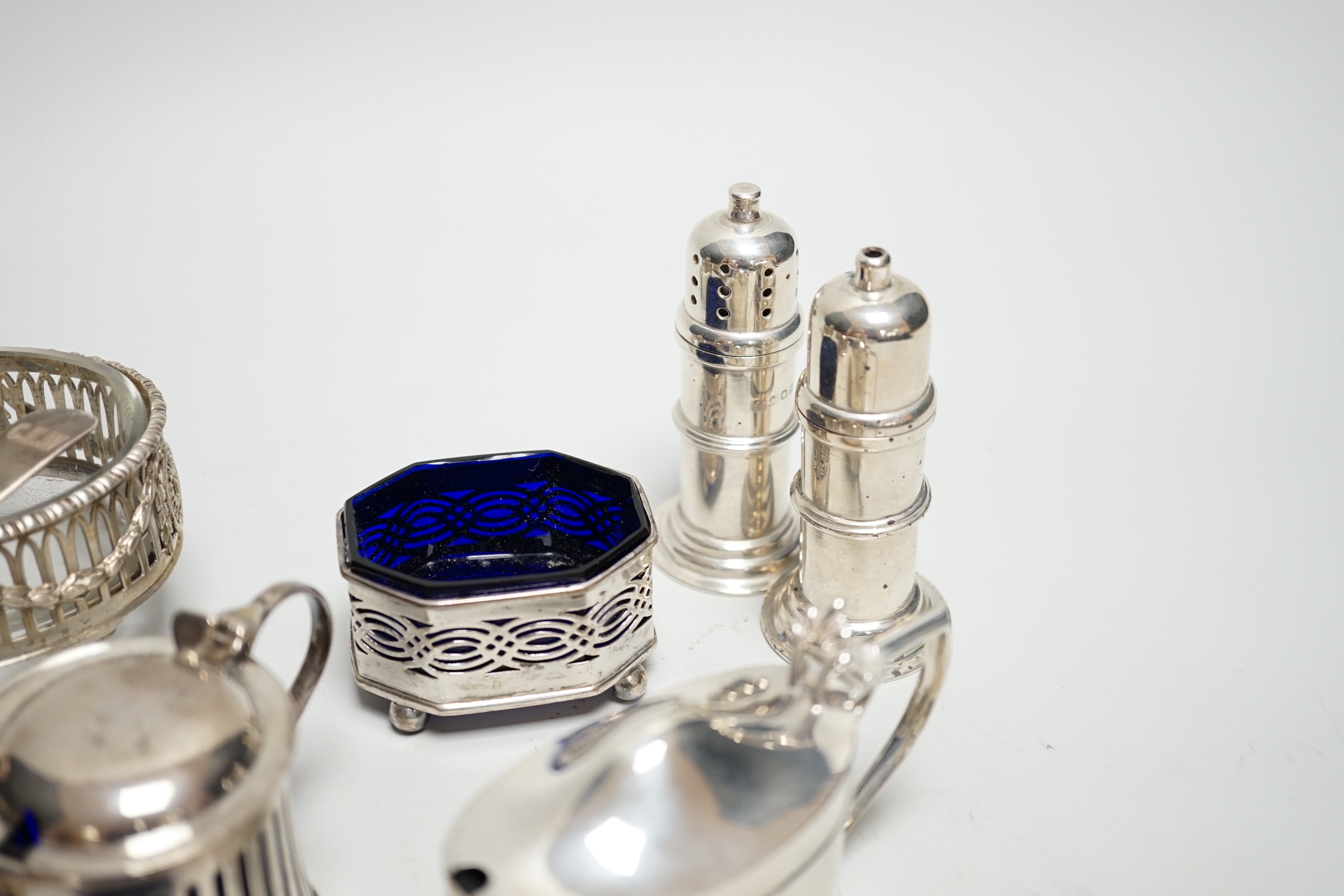 Eight assorted silver condiments, including a George III oval salt and four other items including small inkwell.